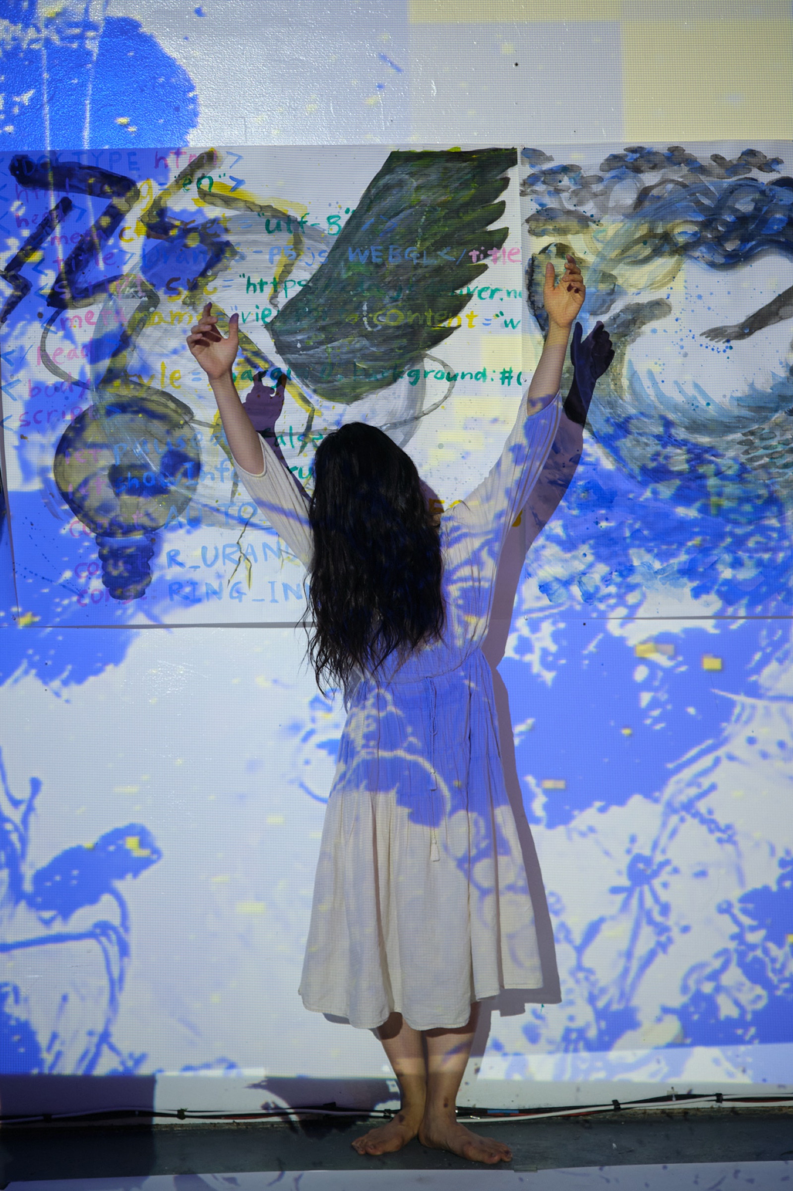Live performance with body-mapped code and painted wing projection